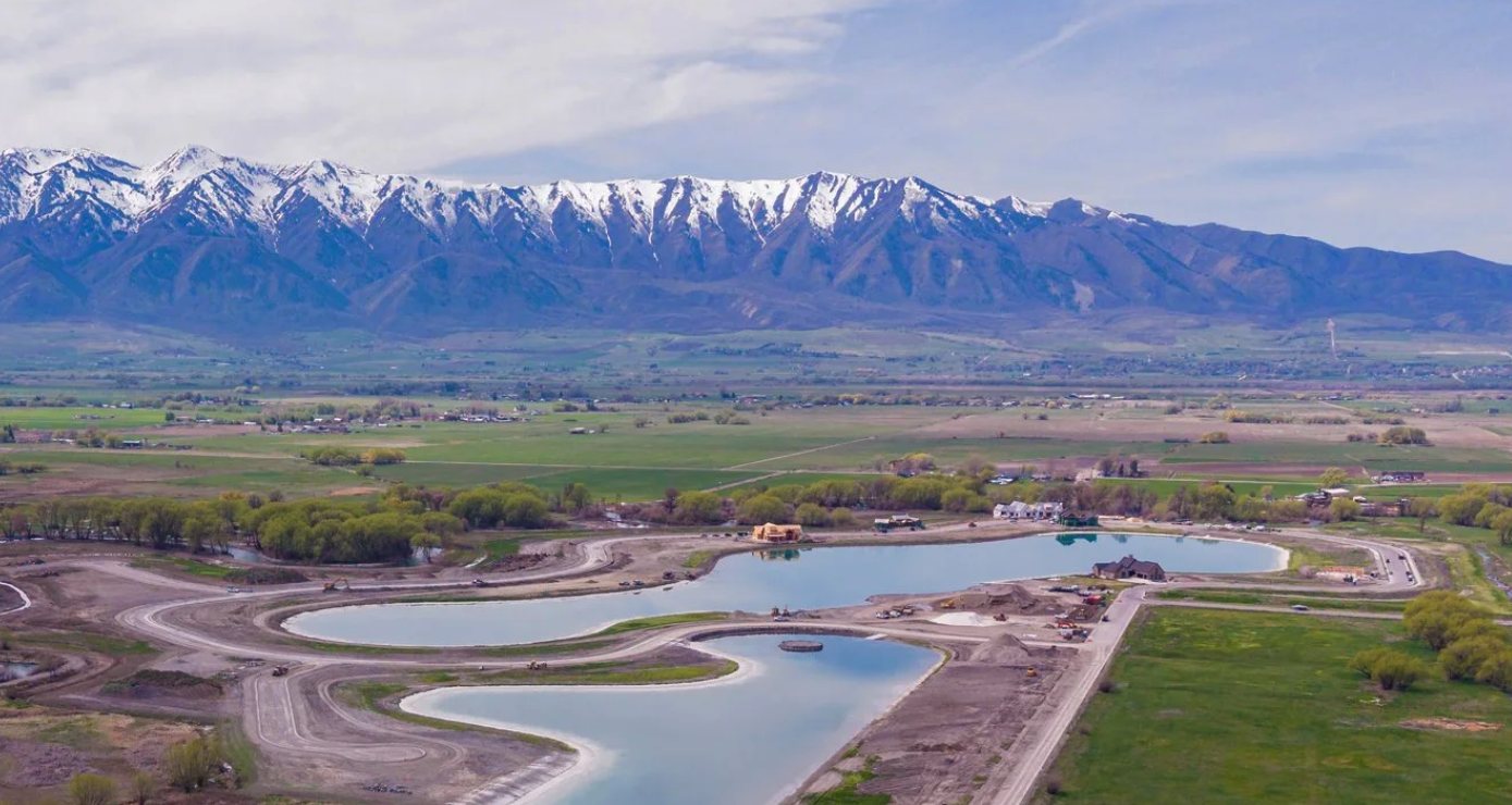 Aerial view of the two private recreation lakes at Willow Lakes with the snow-capped Wellsville Mountains behind